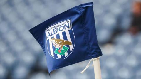 A corner flag with the West Brom badge