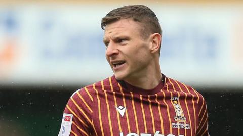 Paul Mullin in action for Bradford City in the club's claret and amber home shirt