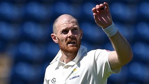 Glamorgan bowler James Harris prepares to catch the ball