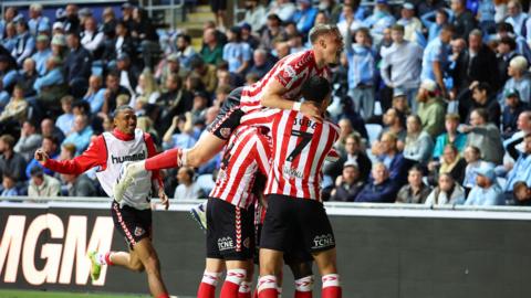 Eliezer Mayenda of Sunderland celebrates scoring his team's second goal with teammates during the Championship Play-Off Semi Final First Leg match between Coventry City and Sunderland at The Coventry Building Society Arena