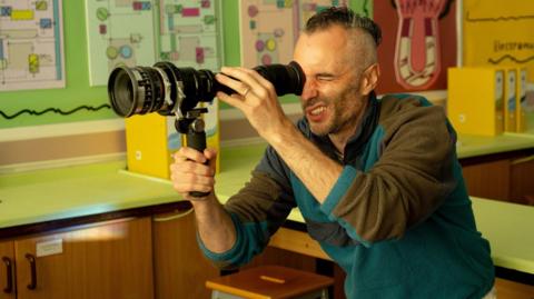 Andy Newbery looking through a viewfinder