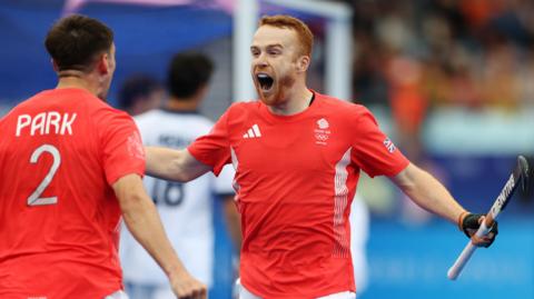 Great Britain's Nicholas Park and Jack Waller celebrate a goal against Spain in the hockey