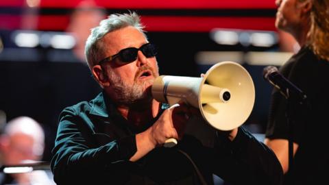 Guy Garvey holding a megaphone