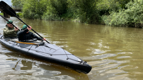 Two Royal Marines paddling a kayak