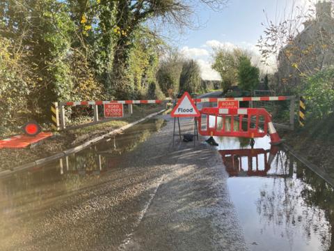 Flood gates with flood sign in front of it