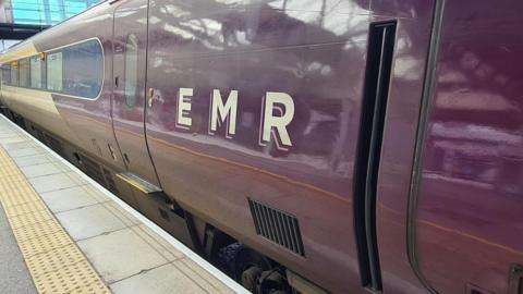 View of an EMR passenger coach at a station