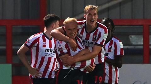 Cheltenham players celebrate their second goal