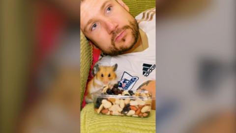 Chris Davies and his hamster, Popcorn