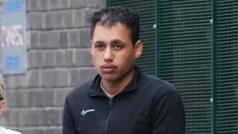 A man in a Nike jumper. 