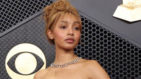 PinkPantheress poses on the red carpet during a premiere ceremony.