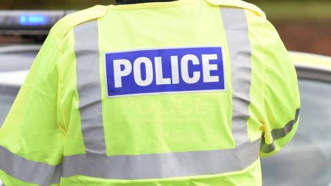 Police jacket from behind.