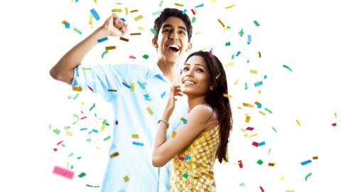Jamal (Dev Patel) and Latika (Freida Pinto) covered in multicoloured confetti