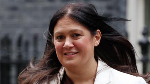 Culture Secretary Lisa Nandy smiles as she looks towards the camera. She has long brown hair and is wearing a white jacket