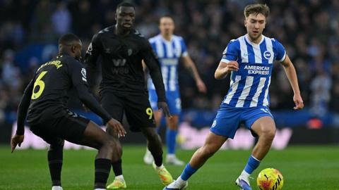 Brighton's Jack Hinshelwood (R) runs with the ball