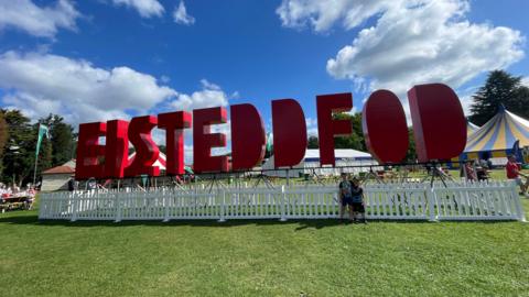 Harry, 7, and Freddie, 5, outside the National Eisteddfod sign in Pontypridd