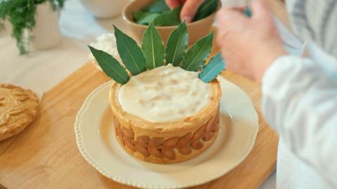 Macaroni cheese pie on a plate.