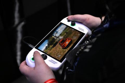 Person holding handheld Xbox 
