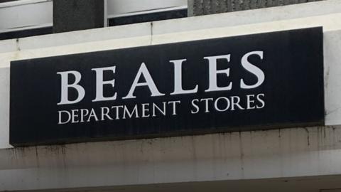 The black and white Beales shop sign.