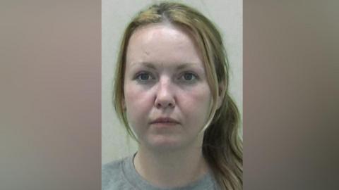 Mugshot of Lawson. She has long blonde hair tied back in a ponytail.