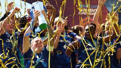 Millie Bright lifts trophy