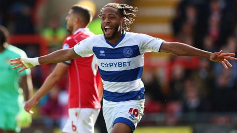 Rumarn Burrell celebrates scoring for QPR with his arms outstretched