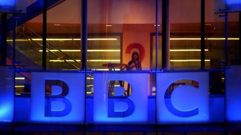 An employee walks inside BBC headquarters at New Broadcasting House