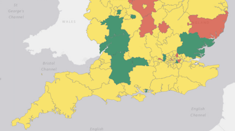 A map showing the south of England, broken up by different regions. Gloucestershire and Wiltshire are coloured in green, while the surrounding regions are mostly amber while three are red. 