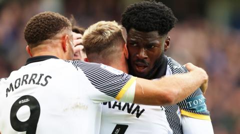 Derby players celebrate a goal