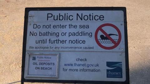 A sign indicating that people should not enter the sea, bathe or paddle until further notice at Palm Bay, Margate, Kent.
