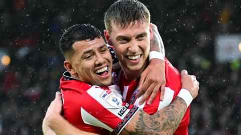 Gus Hamer and Mark McGuinness celebrate