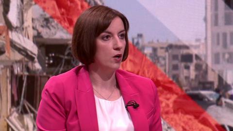 Bridget Phillipson in hot pink blazer and white shirt sitting down in a chair