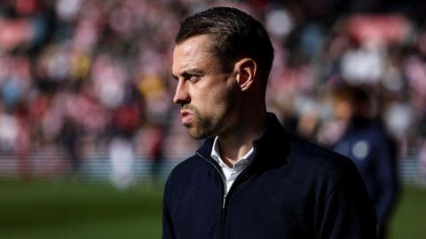 Tonda Eckert looks on from the sidelines
