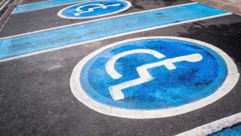 Disabled parking bays are painted in a car park