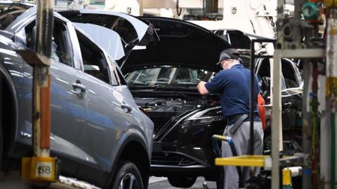 An employee works on a Nissan Qashqai car on the production line at the Nissan factory in Sunderland