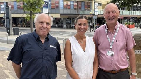 Alan Heels, Adele Wylie and Phil Doherty stand side-by-side in Corby town centre.