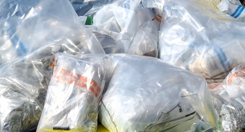 Packages of suspected cocaine and cannabis in bags.