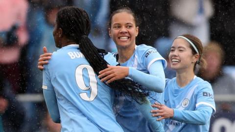 Manchester City celebrate a goal against Arsenal in the WSL