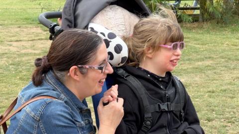 Louisa and her daughter Anna watch other children play