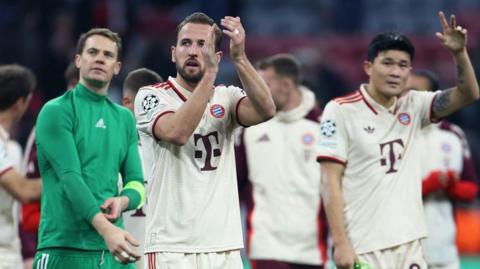 Harry Kane is flanked by Manuel Neuer and Kim Min-jae at Bayern Munich