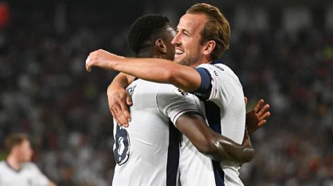 Harry Kane (R) celebrates with Marc Guehi