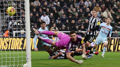 Vitaly Janelt scores his team's first goal past Newcastle goalkeeper Nick Pope
