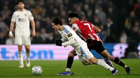 Leeds United's US midfielder #11 Brenden Aaronson is brought down by Brentford's German midfielder #07 Kevin Schade during the English Premier League football match between Leeds United and Brentford at Elland Road
