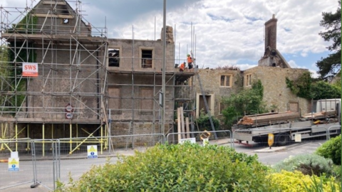 Newell House, a derelict former school surrounded by scaffolding after a fire last month.