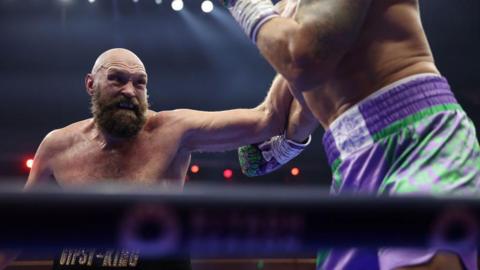Tyson fury aims a punch in the ring