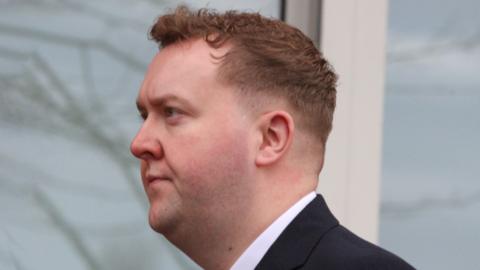 man in suit outside court