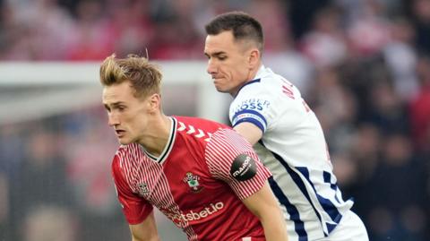 Southampton's Flynn Downes (left) and West Bromwich Albion's Jed Wallace battle for the ball