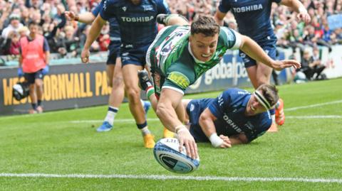 Adam Radwan dives over for his first try against Sale Sharks