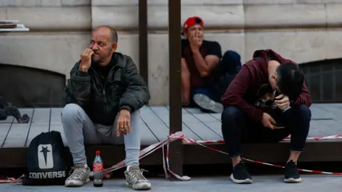 People sit, as a power outage hits large parts of Spain, in Valencia, Spain