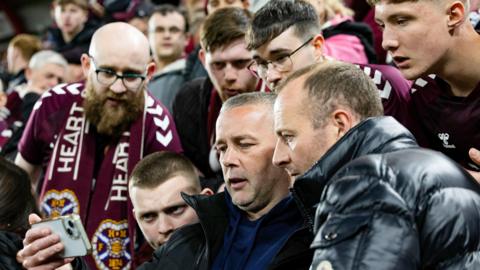 Hearts fans watch the closing stages of Celtic's match at Motherwell