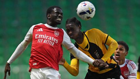 Habeeb Ogunneye of Newport County is challenged by Charles Sagoe Jr of Arsenal U21
